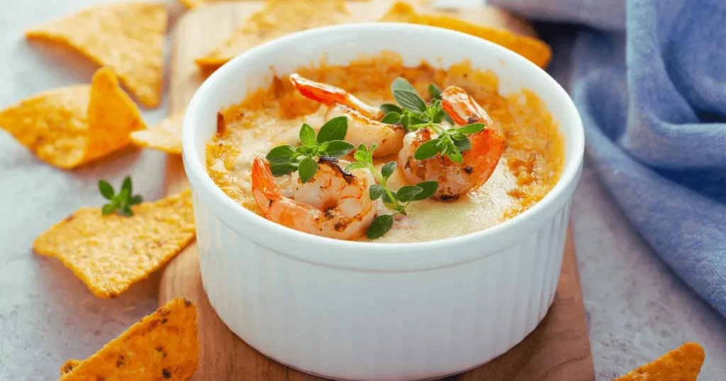 Crab brulee topped with shrimp and herbs.